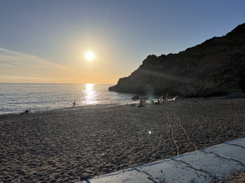 The low sun setting in the sky in December on Playa Cantarrijan in Andalucia