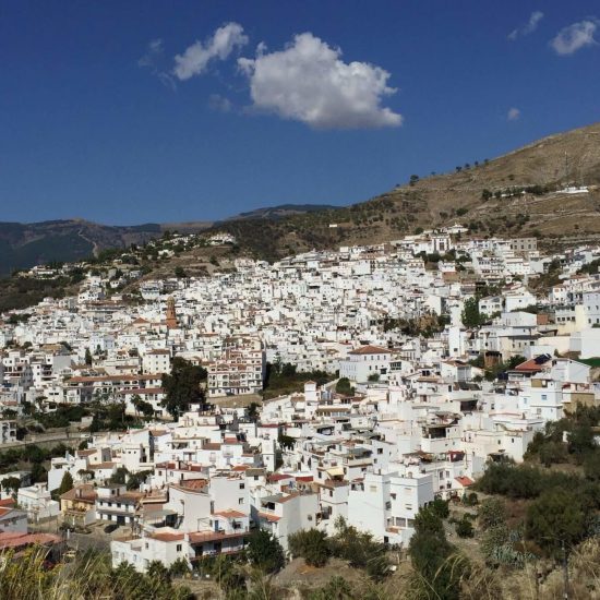 Artistic holidays in Cómpeta, The image shows the white Andalucian pueblo of Cómpeta, tucked into the mountainside.